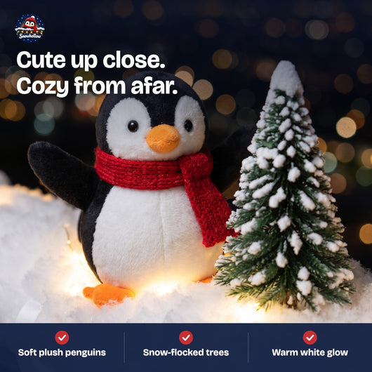 Close-up of a plush penguin with red scarf and snow-flocked tree
